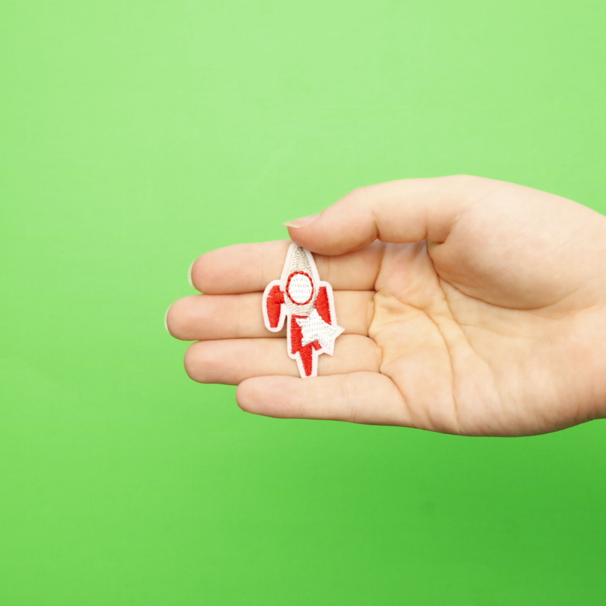 Small Red Rocket Ship With A Star Embroidered Iron On Patch 