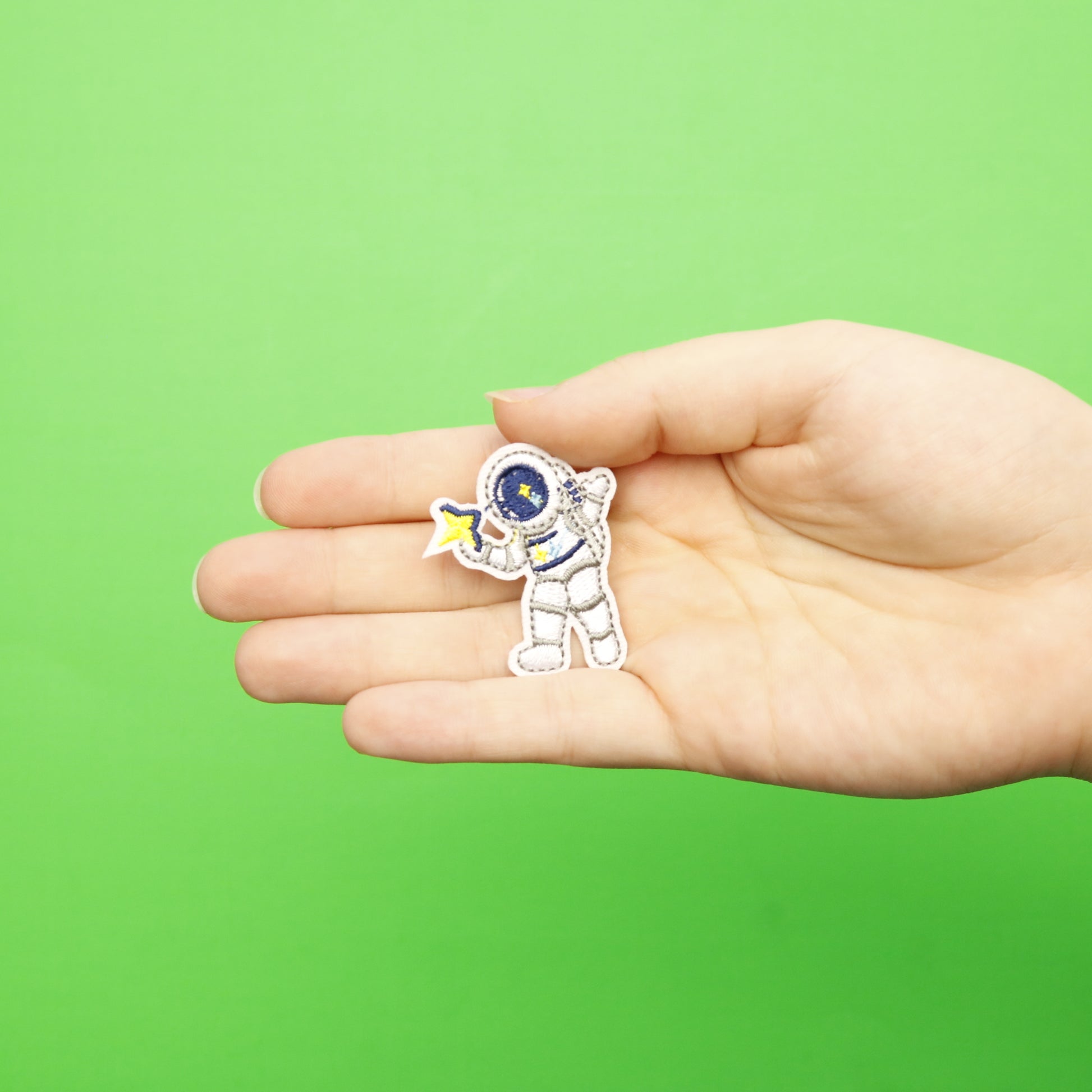 Small Grey Astronaut Holding A Star Embroidered Iron On Patch 